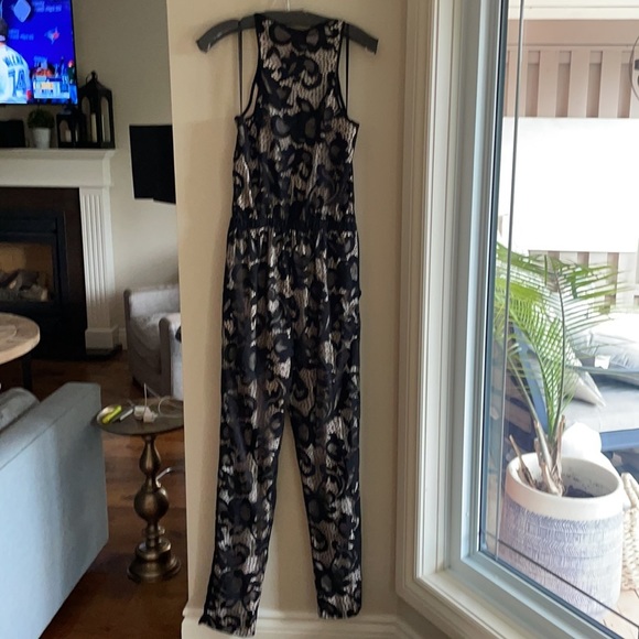 DVF SHANY BLACK LACE JUMPSUIT 6. Bought on Poshmark but it sadly does not fit. - Picture 11 of 12